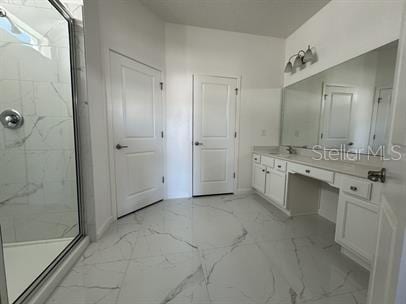 bathroom featuring vanity and an enclosed shower