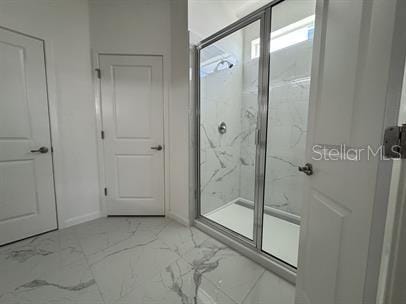 bathroom featuring a shower with shower door