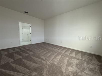 carpeted spare room with lofted ceiling