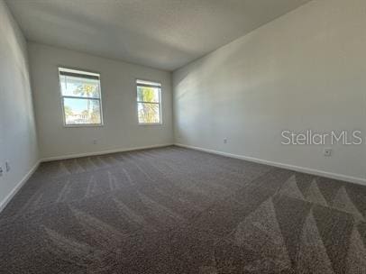 empty room with dark carpet