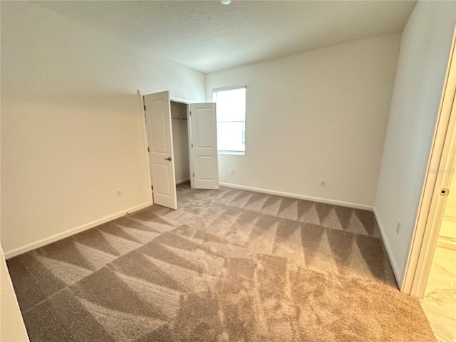 unfurnished bedroom featuring carpet floors and a textured ceiling