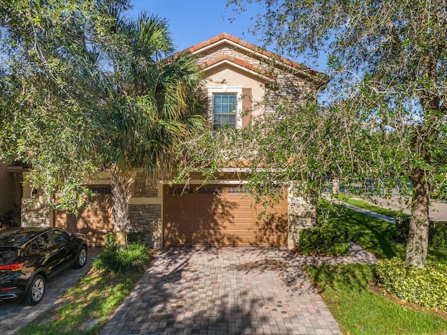 mediterranean / spanish home featuring a garage