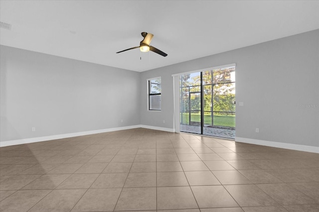 tiled empty room featuring ceiling fan