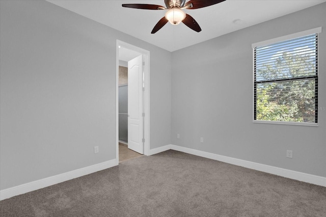 unfurnished room with ceiling fan, a healthy amount of sunlight, and light colored carpet