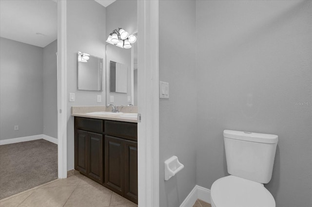 bathroom featuring tile patterned flooring, vanity, and toilet