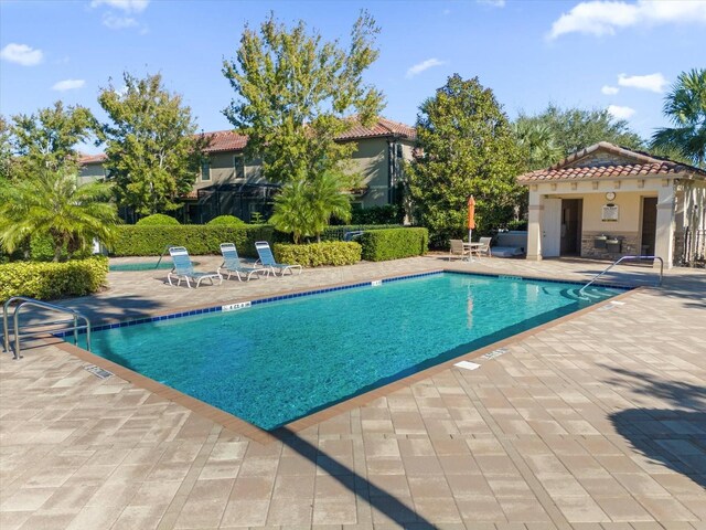 view of swimming pool with a patio