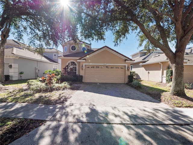 8320 Via Bella Notte, Orlando, FL 32836 - view of front of home featuring stucco siding, a garage, and decorative driveway