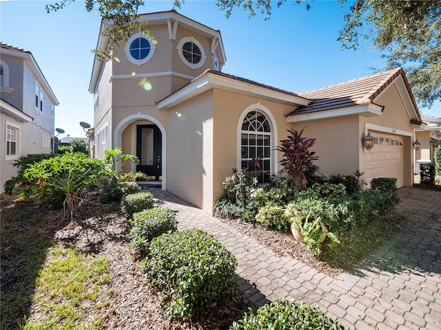 8320 Via Bella Notte, Orlando, FL 32836 - view of front of house with an attached garage, stucco siding, and a tile roof