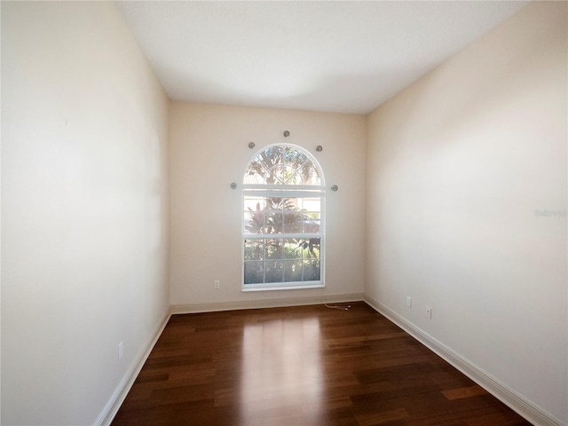 empty room with dark wood-type flooring