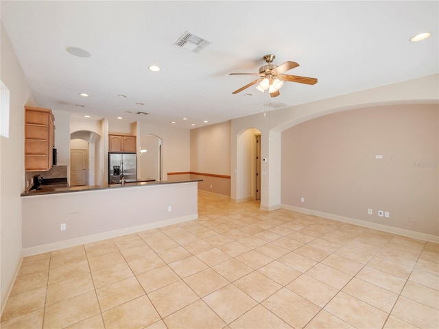 interior space with ceiling fan