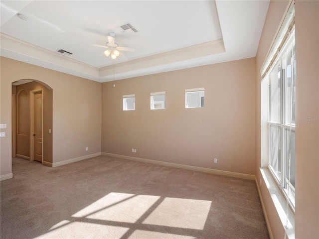 8320 Via Bella Notte, Orlando, FL 32836 - unfurnished room with a tray ceiling, light carpet, arched walkways, and a ceiling fan