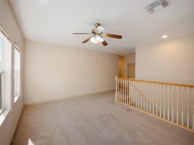 carpeted empty room with ceiling fan