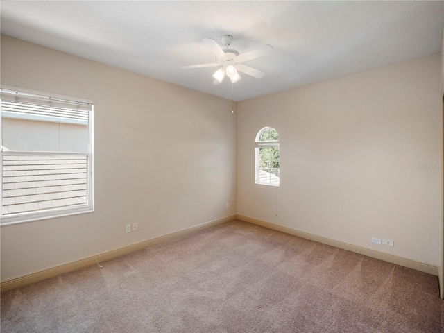 empty room featuring light carpet and ceiling fan