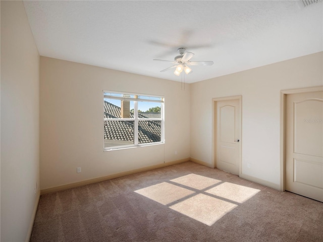 unfurnished bedroom featuring ceiling fan and light colored carpet