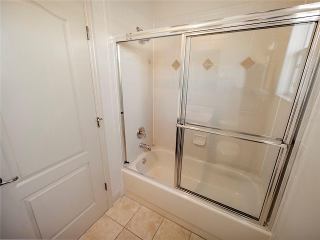 bathroom featuring tile patterned floors and shower / bath combination with glass door