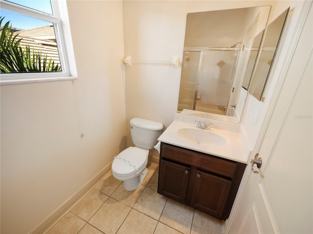 bathroom with tile patterned flooring, vanity, toilet, and walk in shower