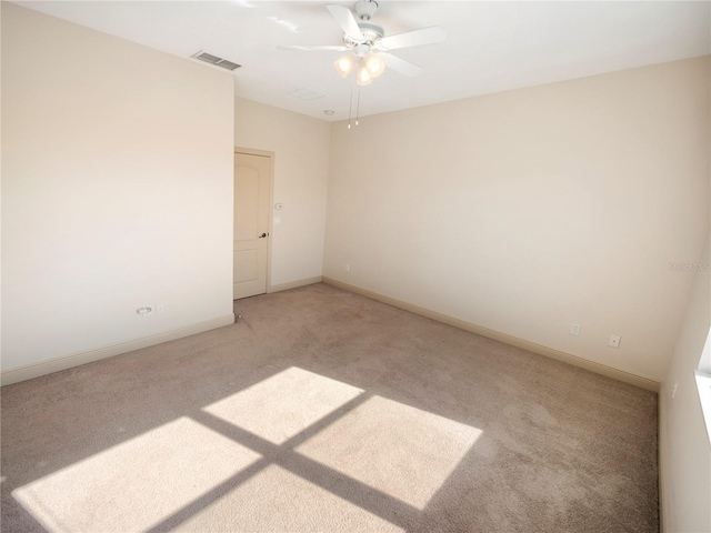 carpeted spare room with ceiling fan