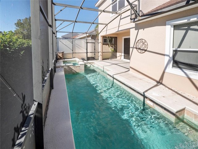 view of pool with an in ground hot tub, a patio area, and a lanai