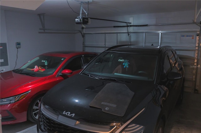 garage with electric panel and a garage door opener