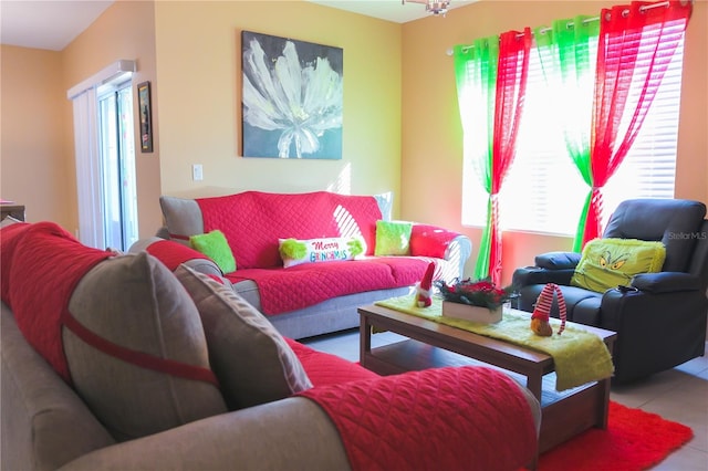 tiled living room featuring a chandelier