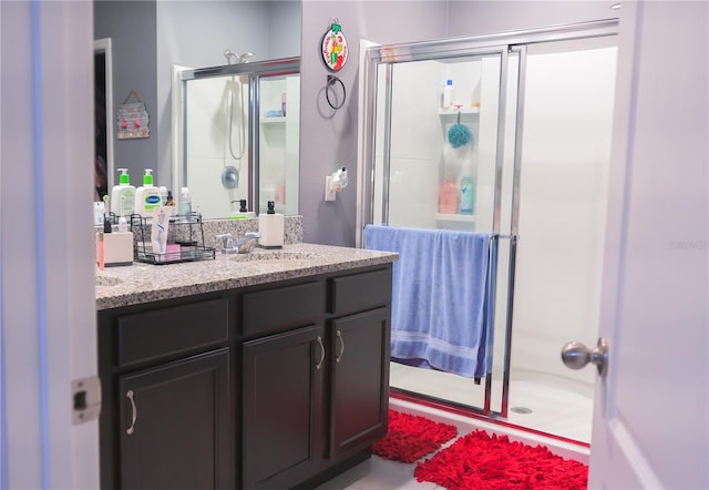 bathroom featuring vanity and a shower with shower door