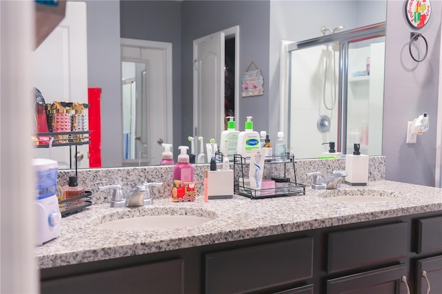 bathroom with vanity and a shower with shower door