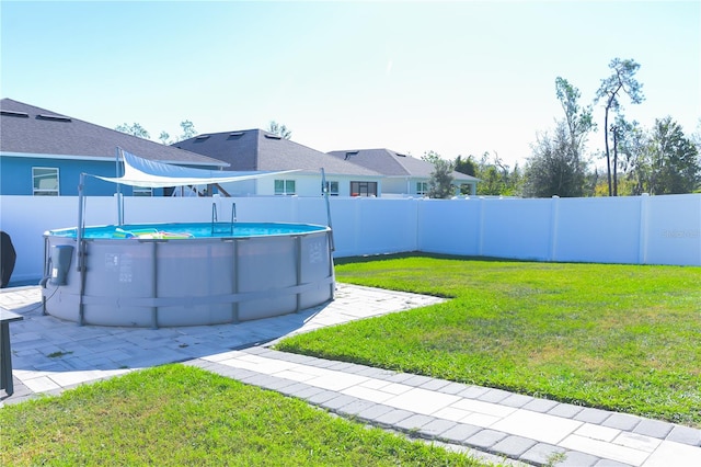 view of yard with a fenced in pool