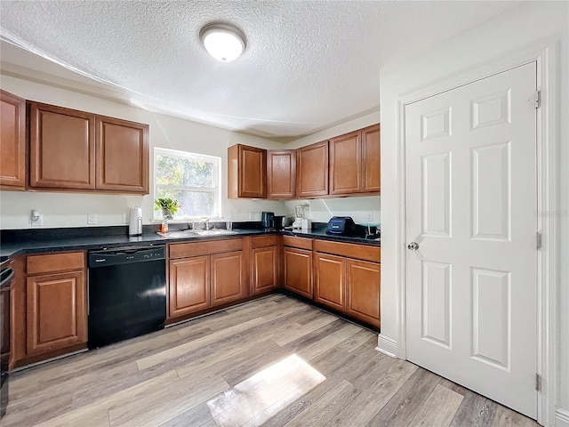 kitchen with dishwasher, a textured ceiling, light wood-type flooring, and sink