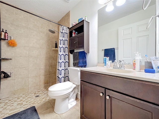 bathroom featuring vanity, tile patterned flooring, toilet, a textured ceiling, and curtained shower