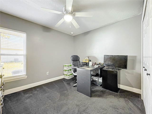 office with dark colored carpet, a textured ceiling, and ceiling fan