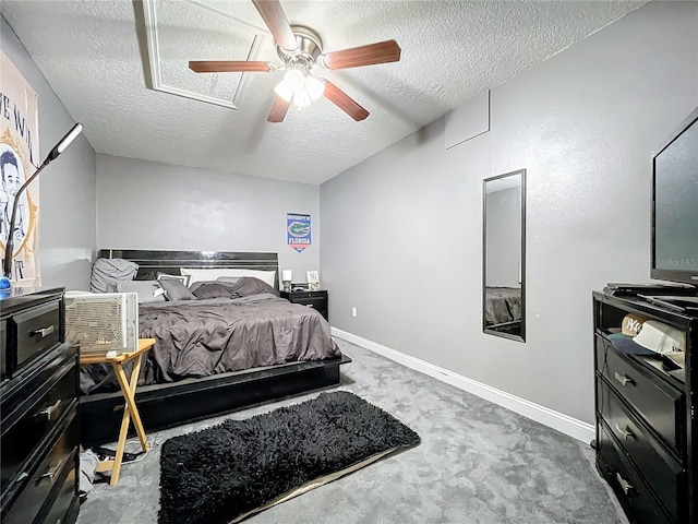 bedroom featuring carpet flooring, ceiling fan, and a textured ceiling