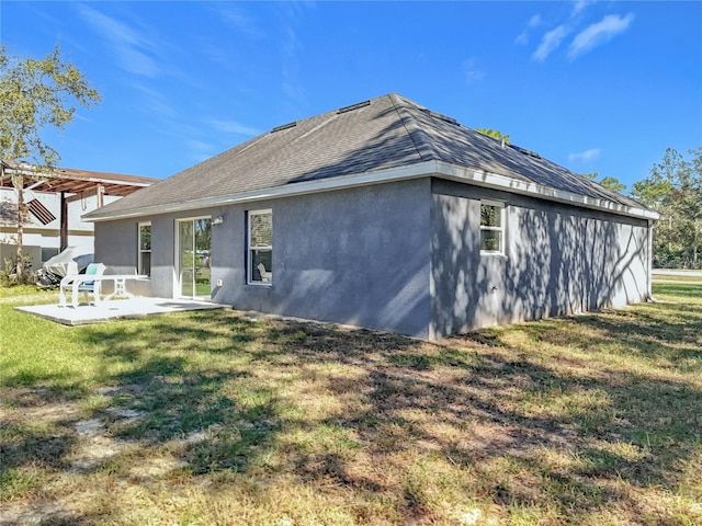 rear view of house featuring a pergola, a patio area, and a yard