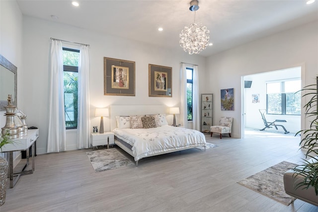 bedroom featuring light hardwood / wood-style floors and a notable chandelier