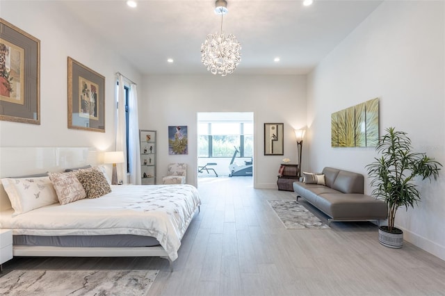 bedroom with wood-type flooring, access to outside, and a chandelier