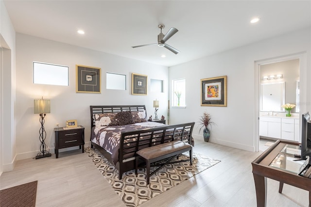 bedroom featuring ensuite bathroom, ceiling fan, and light wood-type flooring