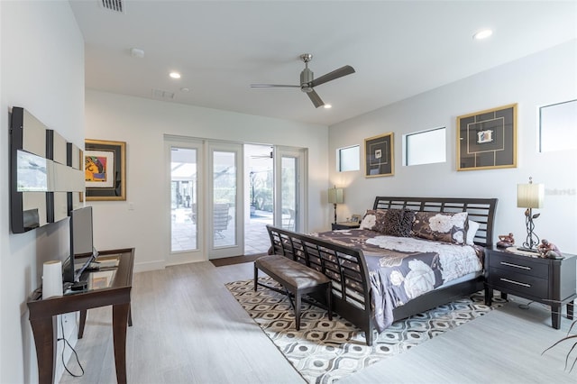 bedroom featuring access to exterior, light hardwood / wood-style floors, and ceiling fan