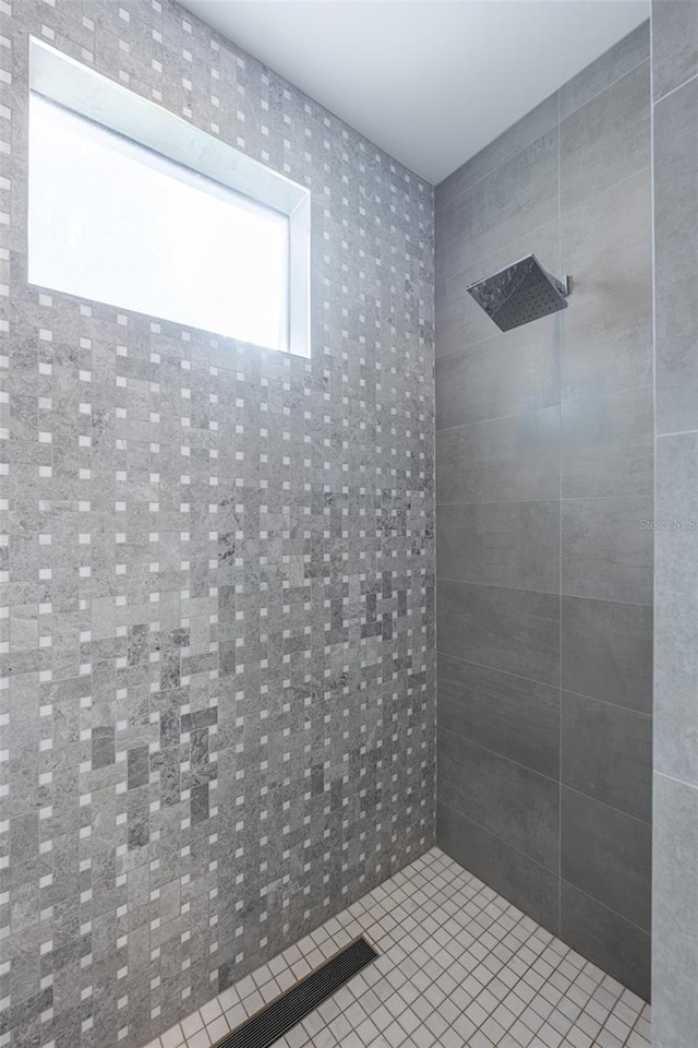 bathroom featuring tiled shower and tile patterned floors