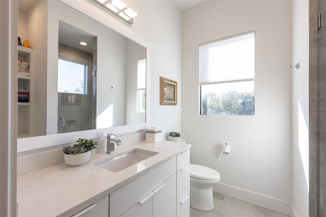 bathroom with plenty of natural light, toilet, a shower with shower door, and vanity