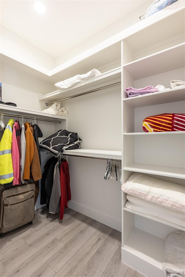 walk in closet featuring light hardwood / wood-style flooring