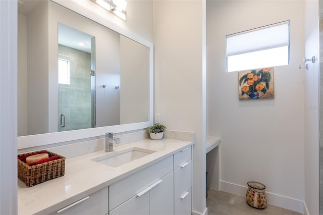 bathroom featuring tile patterned floors, vanity, and a shower with door