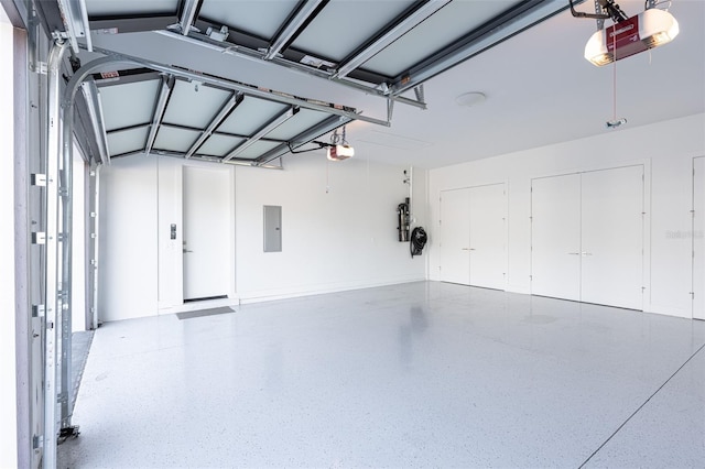 garage featuring electric panel and a garage door opener