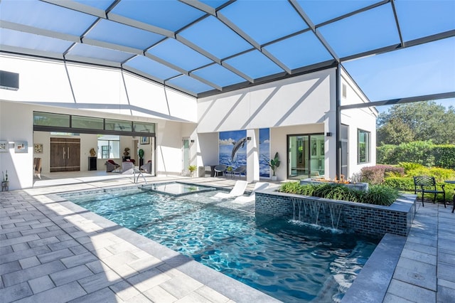 view of pool with glass enclosure, pool water feature, and a patio