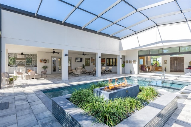 view of swimming pool featuring french doors, an outdoor living space with a fire pit, a lanai, ceiling fan, and a patio