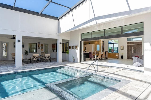 view of swimming pool with an in ground hot tub, outdoor lounge area, a patio area, and a lanai