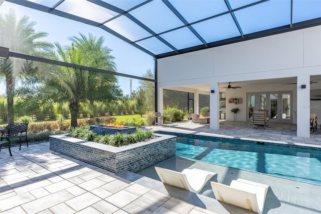 view of pool with ceiling fan, a lanai, and a patio