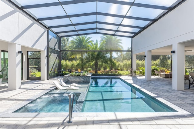 view of swimming pool with a lanai, a jacuzzi, an outdoor living space, pool water feature, and a patio