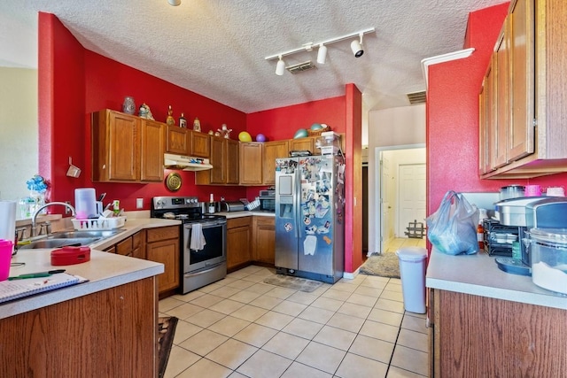 kitchen with a textured ceiling, sink, appliances with stainless steel finishes, and rail lighting