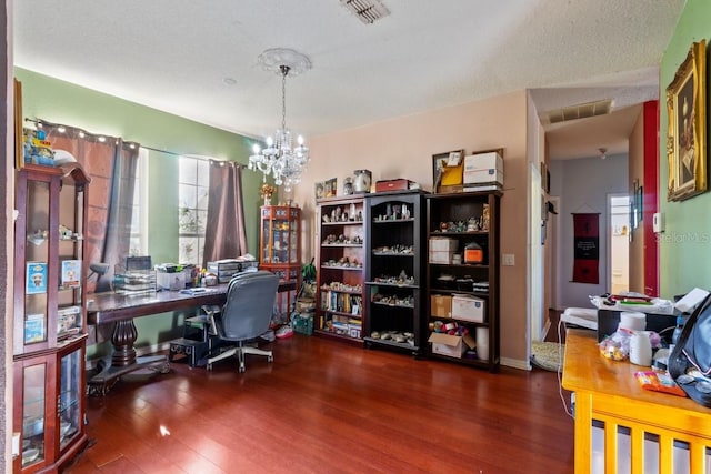 home office with a textured ceiling, dark hardwood / wood-style floors, and an inviting chandelier