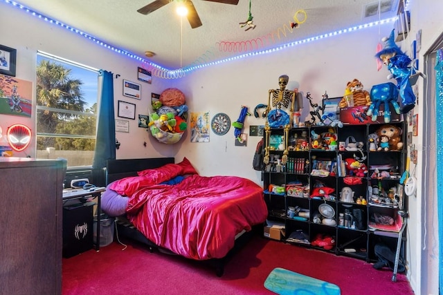 bedroom with carpet, a textured ceiling, and ceiling fan