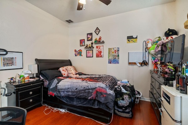 bedroom featuring ceiling fan and dark hardwood / wood-style floors